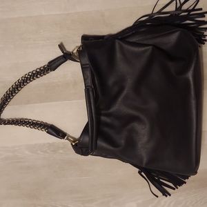 Black vegan faux leather modern tote handbag with slick metal chain and tassels